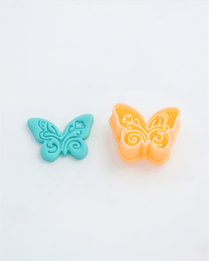 Close product view showing the printed Boho Butterfly clay cutter beside its matching polymer clay imprint.