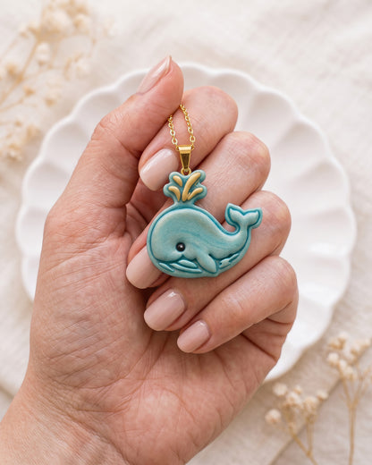 Hand-scale photograph showing the relative size of a finished Cartoon Whale polymer clay piece.