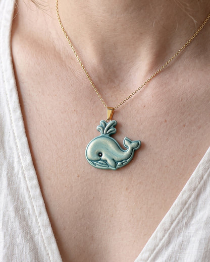 A model wearing finished Cartoon Whale polymer clay jewelry, showing its appearance and scale when worn.