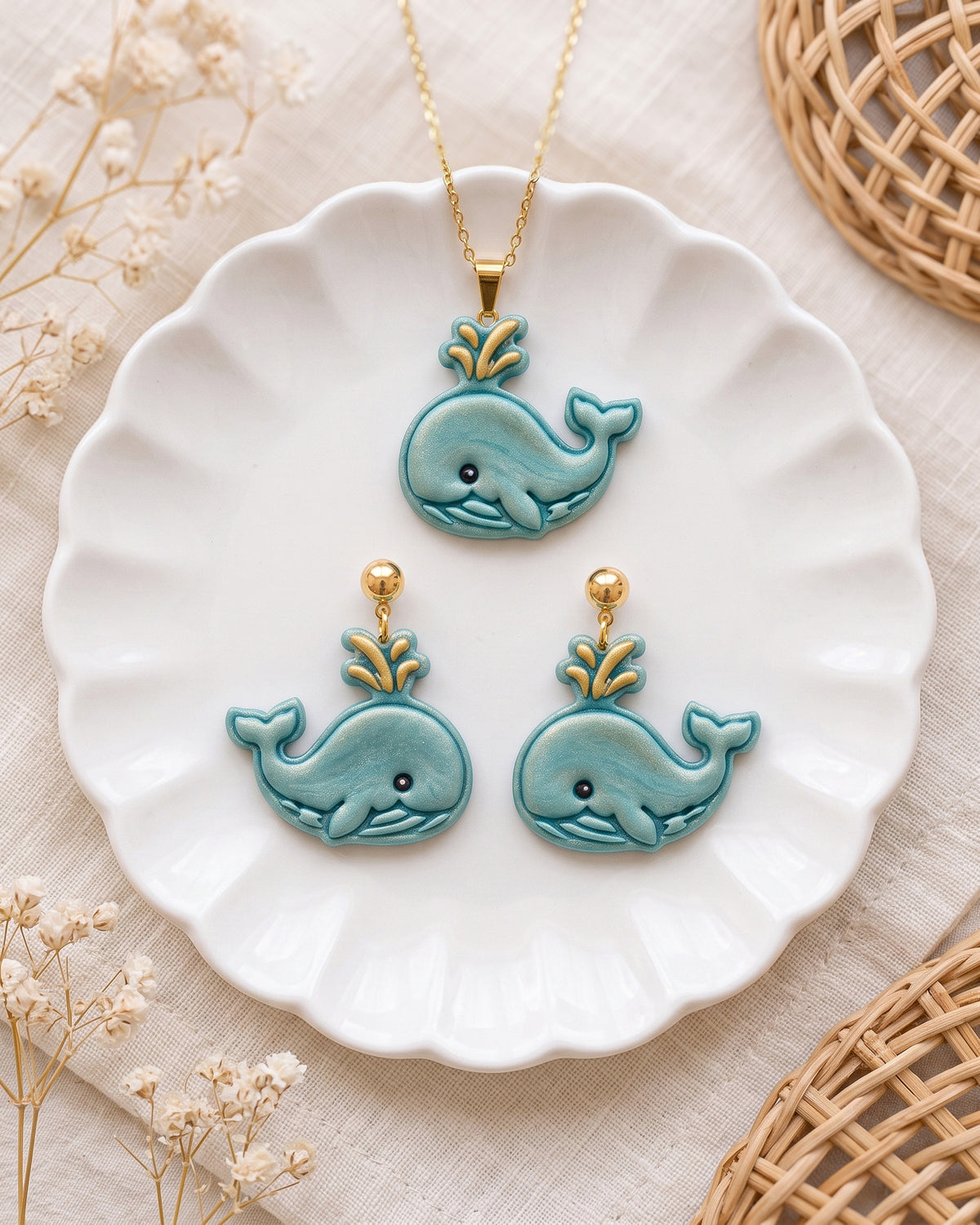 Styled lifestyle scene featuring the Cartoon Whale cutter and finished polymer clay jewelry made with the design.
