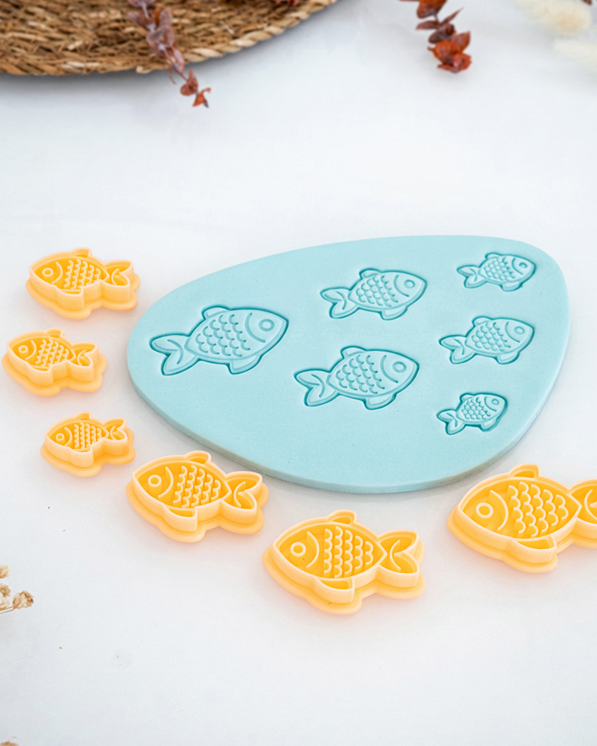 Close product view showing the printed Fish clay cutter beside its matching polymer clay imprint.
