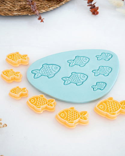 Close product view showing the printed Fish clay cutter beside its matching polymer clay imprint.
