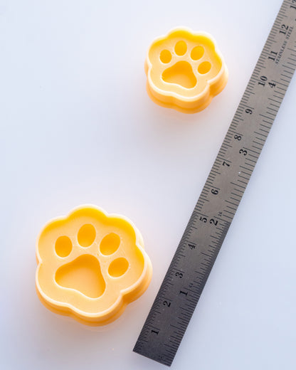 Mini Paw Print clay cutters shown with a ruler or size lineup to provide a practical scale reference.