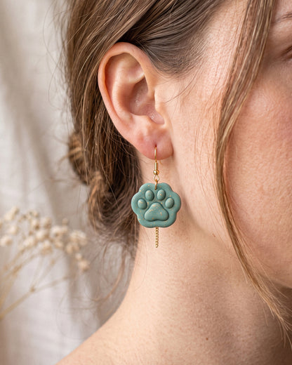 A model wearing finished Mini Paw Print polymer clay jewelry, showing its appearance and scale when worn.