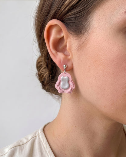 A model wearing finished Mini Penguin polymer clay jewelry, showing its appearance and scale when worn.