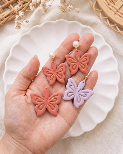 Hand-scale photograph showing the relative size of a finished Ornamental Lotus polymer clay piece.
