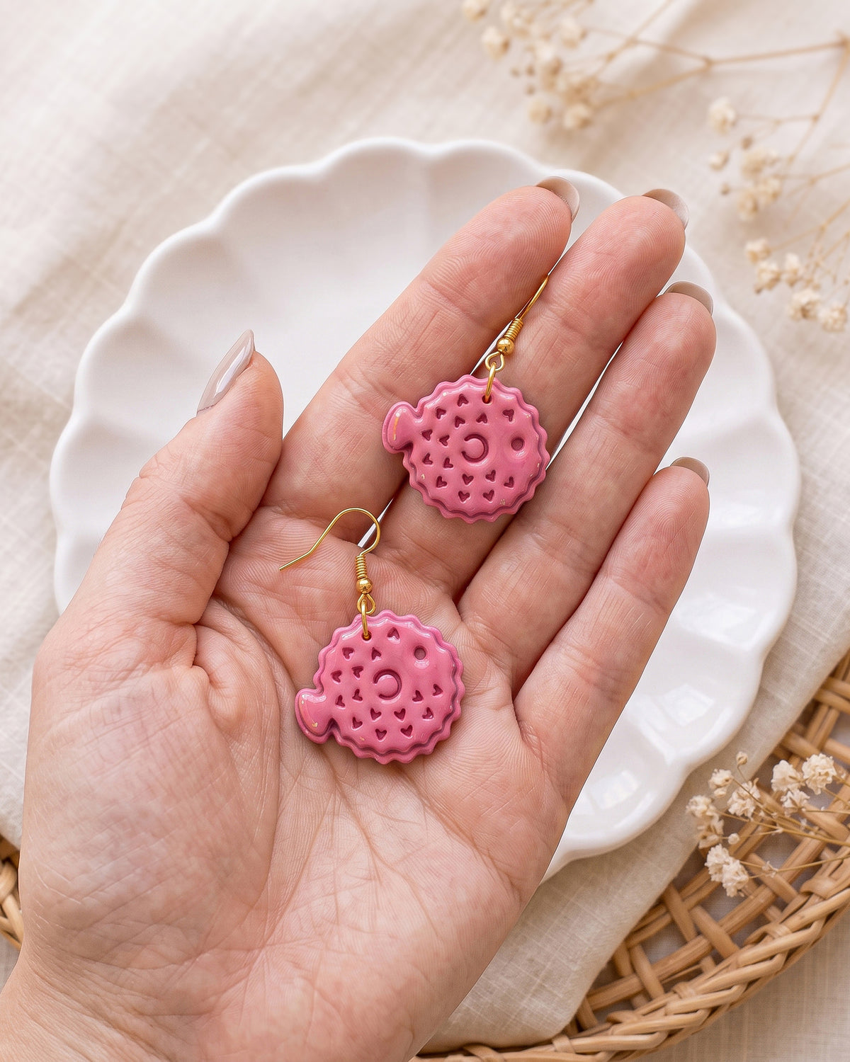 Hand-scale photograph showing the relative size of a finished Pufferfish polymer clay piece.