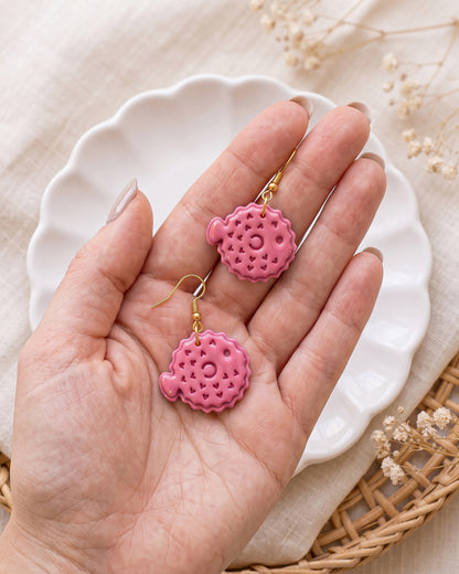 Hand-scale photograph showing the relative size of a finished Pufferfish polymer clay piece.