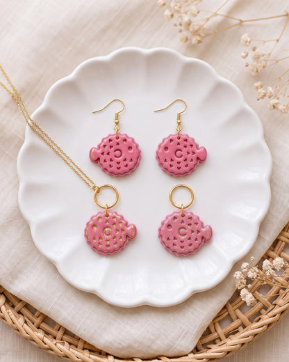 Styled lifestyle scene featuring the Pufferfish cutter and finished polymer clay jewelry made with the design.