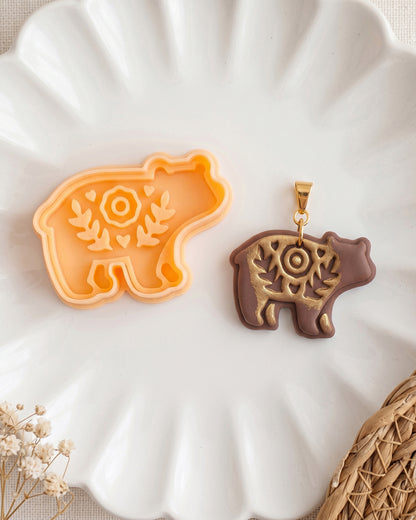 Close product view showing the printed Scandi Folk Bear (Woodland Collection) clay cutter beside its matching polymer clay imprint.