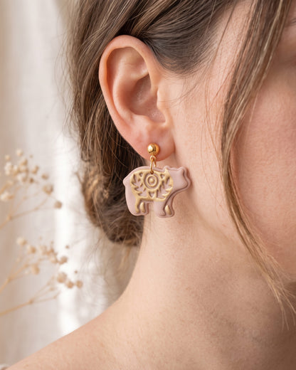 A model wearing finished Scandi Folk Bear (Woodland Collection) polymer clay jewelry, showing its appearance and scale when worn.