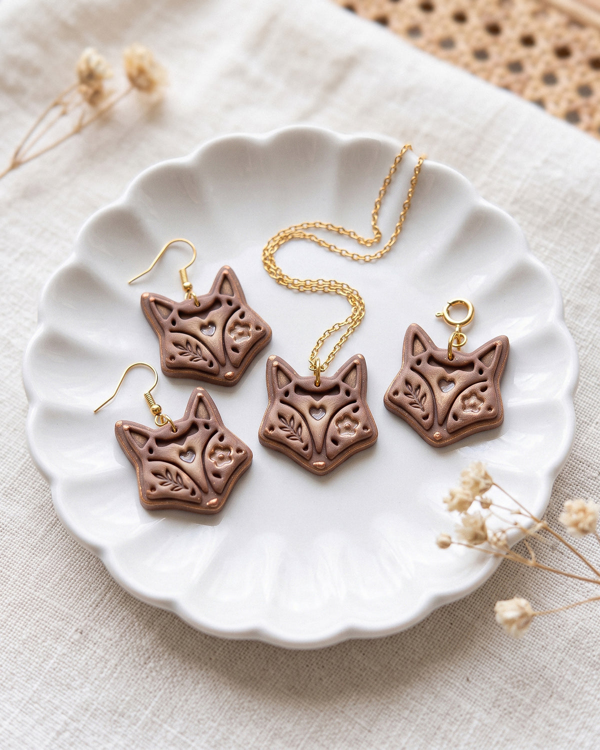 Close view of finished polymer clay jewelry made with the Scandi Folk Fox Head cutter design.