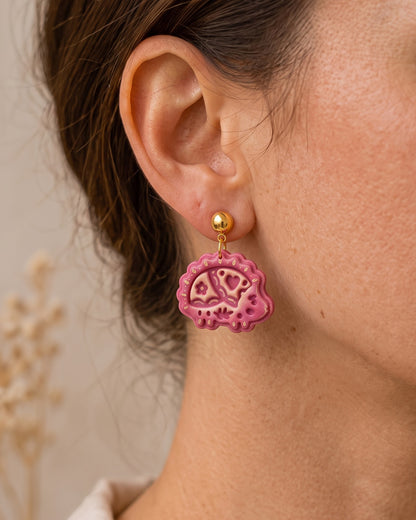 A model wearing finished Scandi Folk Hedgehog polymer clay jewelry, showing its appearance and scale when worn.