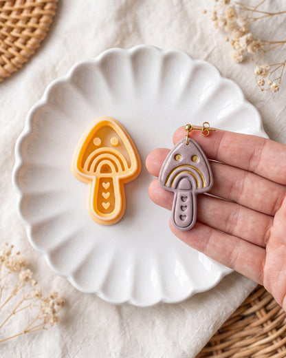 Hand-scale photograph showing the relative size of a finished Scandi Folk Rainbow Mushroom polymer clay piece.