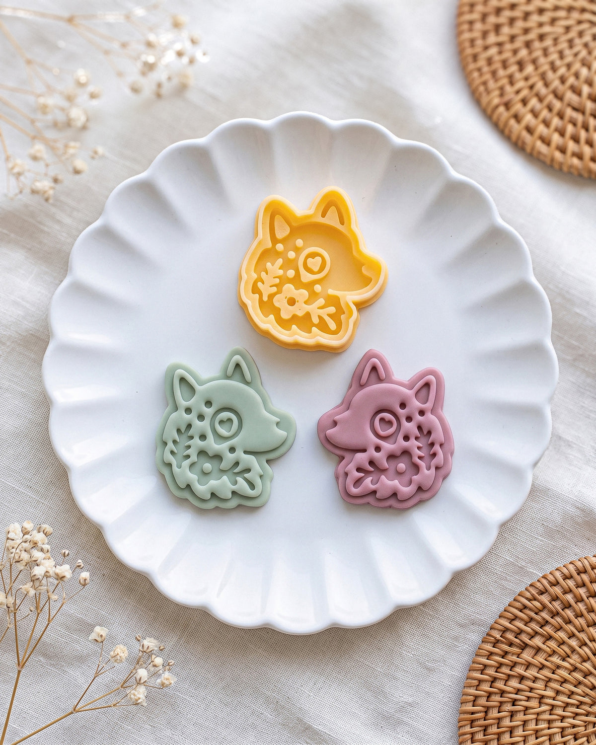 Close product view showing the printed Scandi Folk Wolf Head clay cutter beside its matching polymer clay imprint.