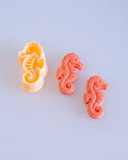 Close product view showing the printed Seahorse clay cutter beside its matching polymer clay imprint.