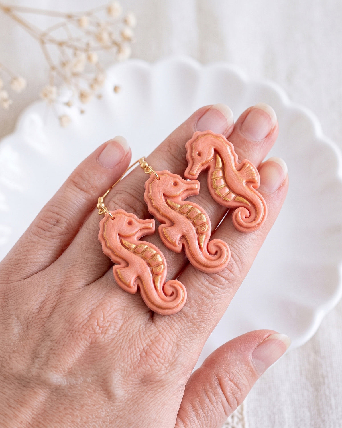 Hand-scale photograph showing the relative size of a finished Seahorse polymer clay piece.