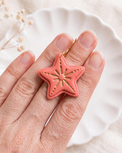 Hand-scale photograph showing the relative size of a finished Starfish polymer clay piece.