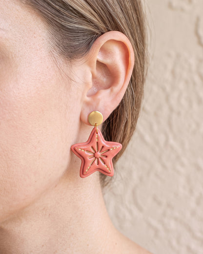 A model wearing finished Starfish polymer clay jewelry, showing its appearance and scale when worn.