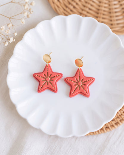 Styled lifestyle scene featuring the Starfish cutter and finished polymer clay jewelry made with the design.