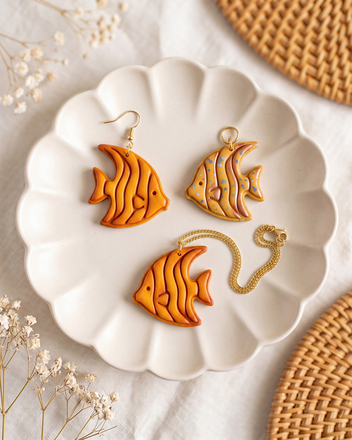 Styled lifestyle scene featuring the Tropical Angelfish cutter and finished polymer clay jewelry made with the design.