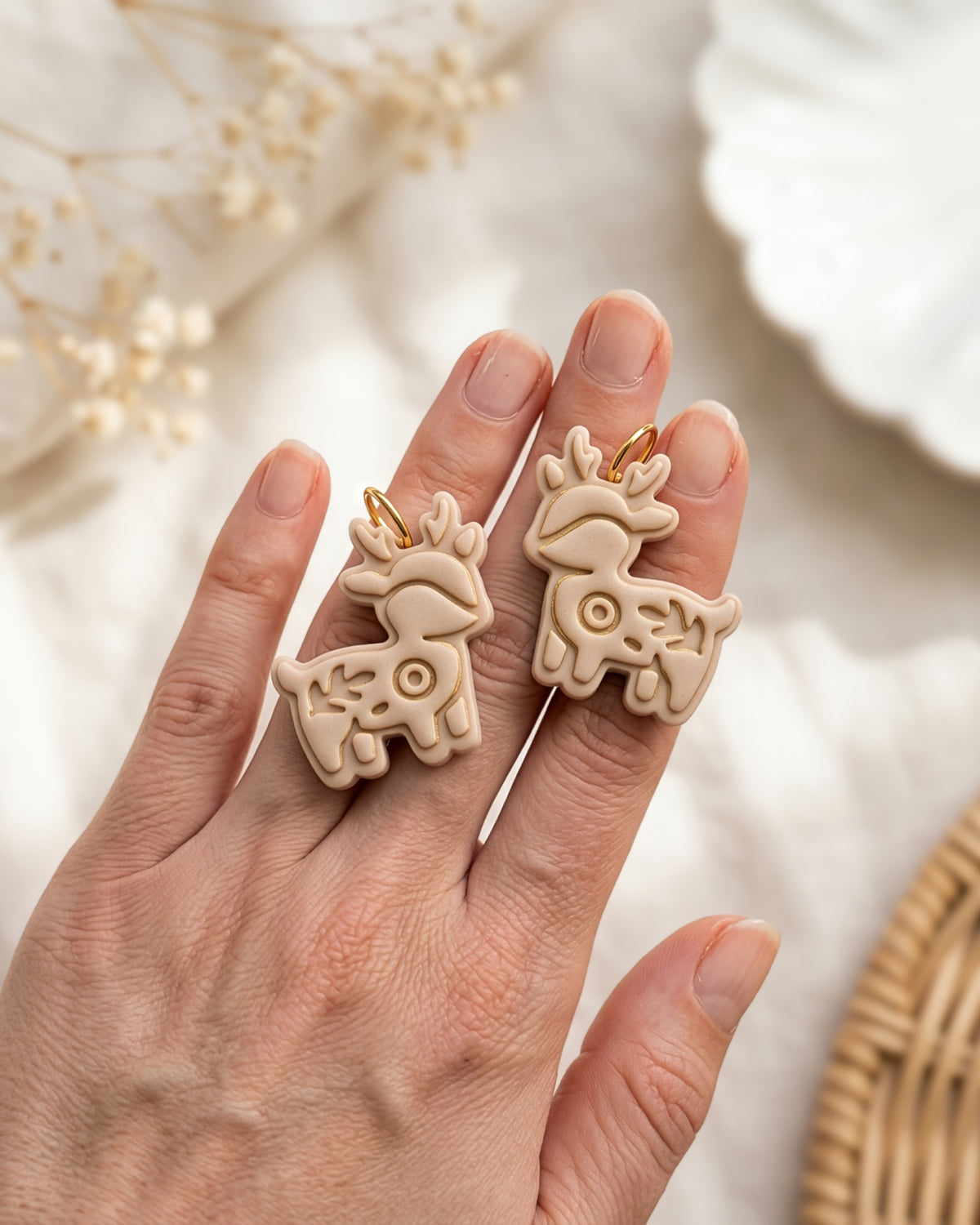 Hand-scale photograph showing the relative size of a finished Woodland Deer polymer clay piece.