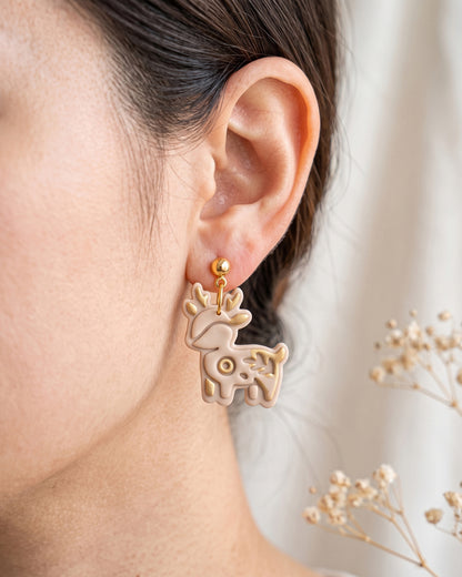 A model wearing finished Woodland Deer polymer clay jewelry, showing its appearance and scale when worn.