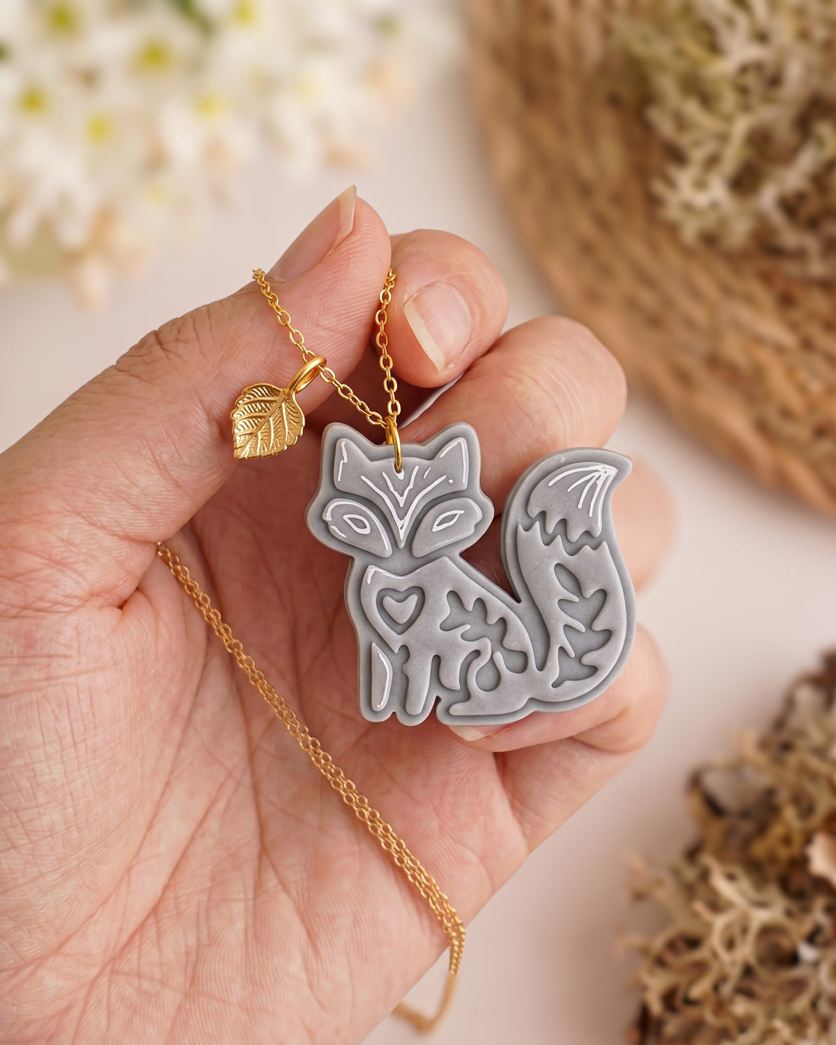 Hand-scale photograph showing the relative size of a finished Woodland Fox polymer clay piece.